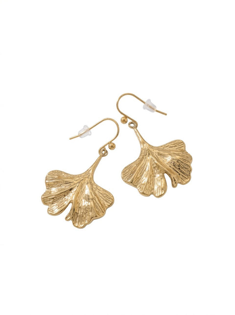 A pair of gold-tone dangle earrings shaped like textured ginkgo leaves, shown on a plain white background.