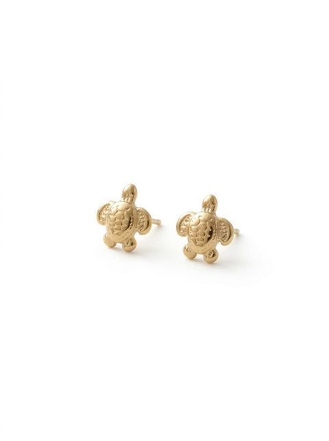 A pair of gold sea turtle stud earrings on a clean white background.