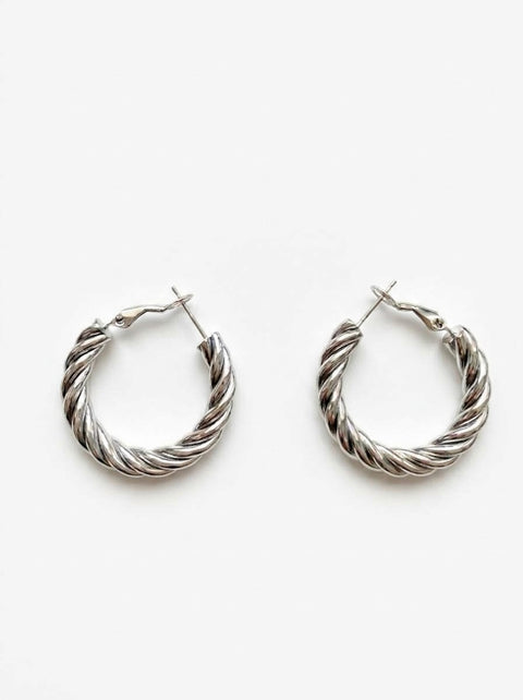 A pair of silver-toned twisted hoop earrings with a textured, rope-like finish, displayed on a clean white background.