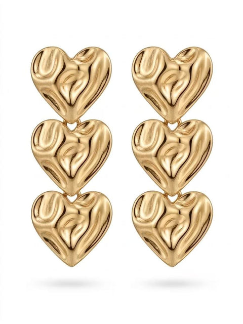A pair of gold heart-shaped drop waterproof earrings, each composed of three stacked textured hearts, shown on a clean white background.