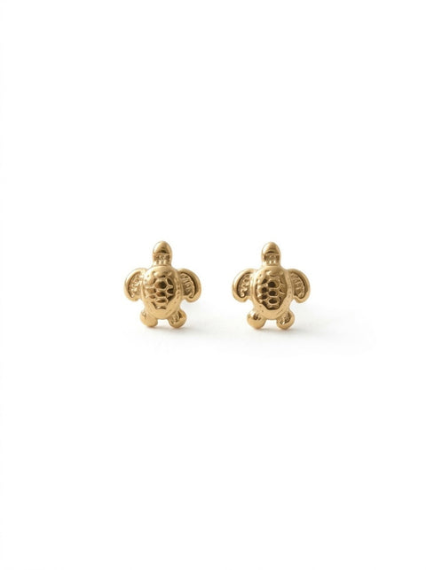 A pair of gold sea turtle stud earrings on a clean white background.